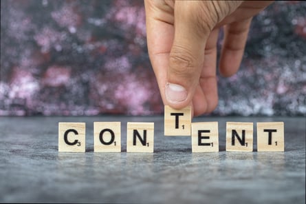 content-writing-with-black-letters-wooden-dices-blue-background-high-quality-photo