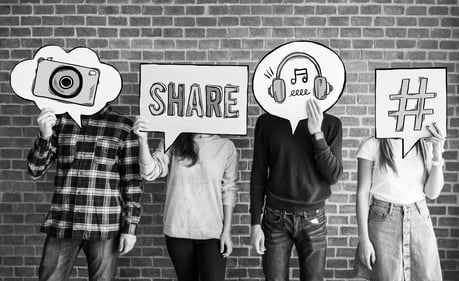 friends-holding-up-thought-bubbles-with-social-media-concept-icons