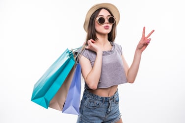 full-length-portrait-happy-excited-girl-bright-colorful-clothes-holding-shopping-bags-while-standing-showing-peace-gesture-isolated