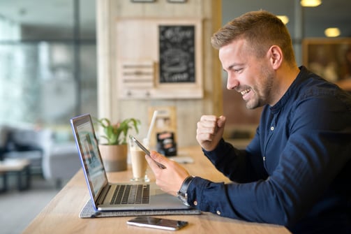 happy-freelancer-with-tablet-laptop-computer-coffee-shop