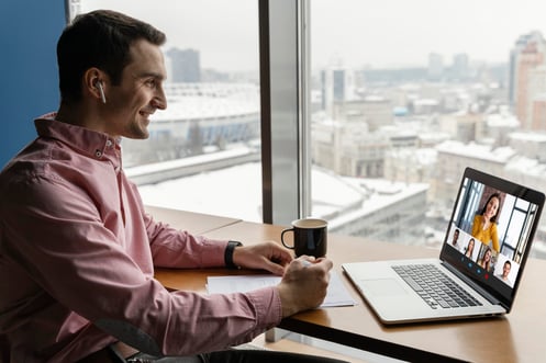 side-view-man-having-online-video-call-with-coworkers
