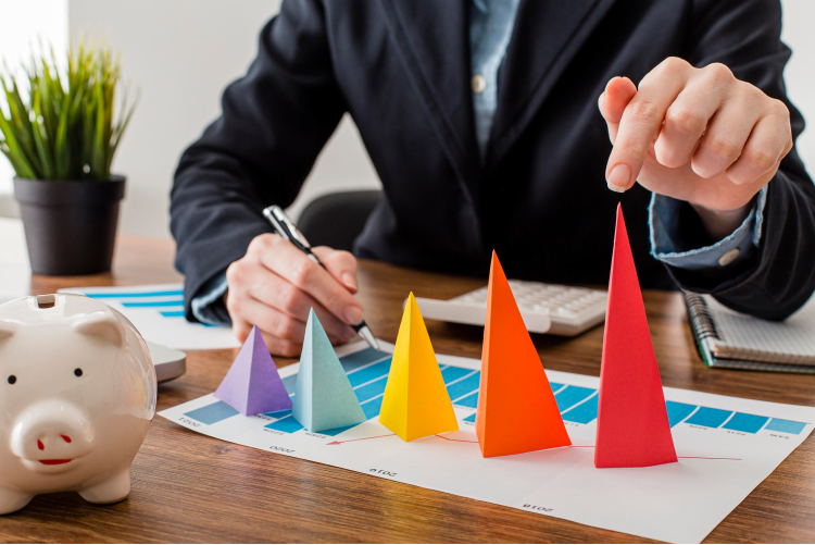 front-view-businessman-with-colorful-cones-representing-growth 1