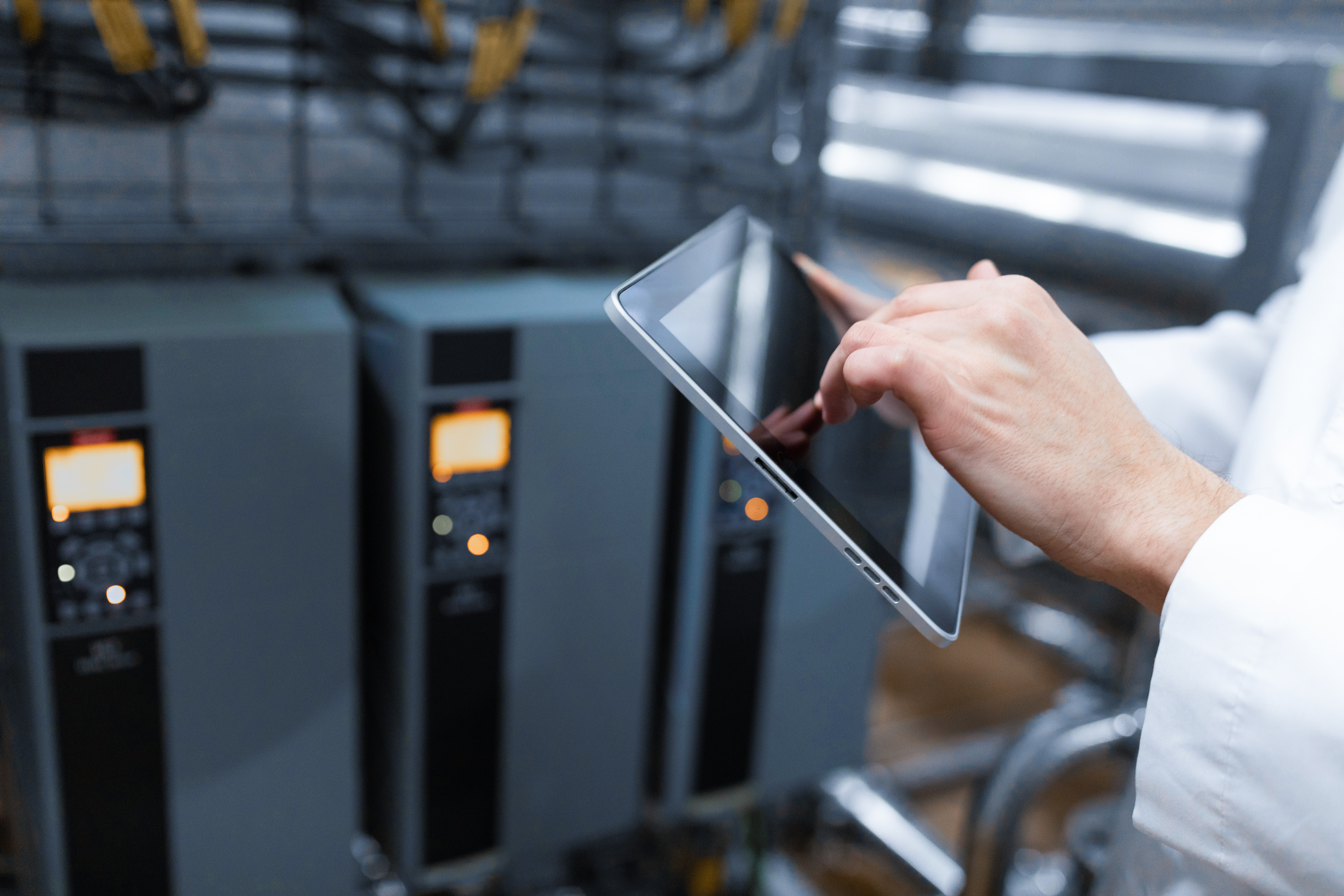 technologist-with-grey-tablet-his-hands-make-set-up-production-line-while-standing-department-dairy-factory