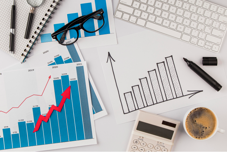 top-view-office-desk-with-growth-chart-glasses 1